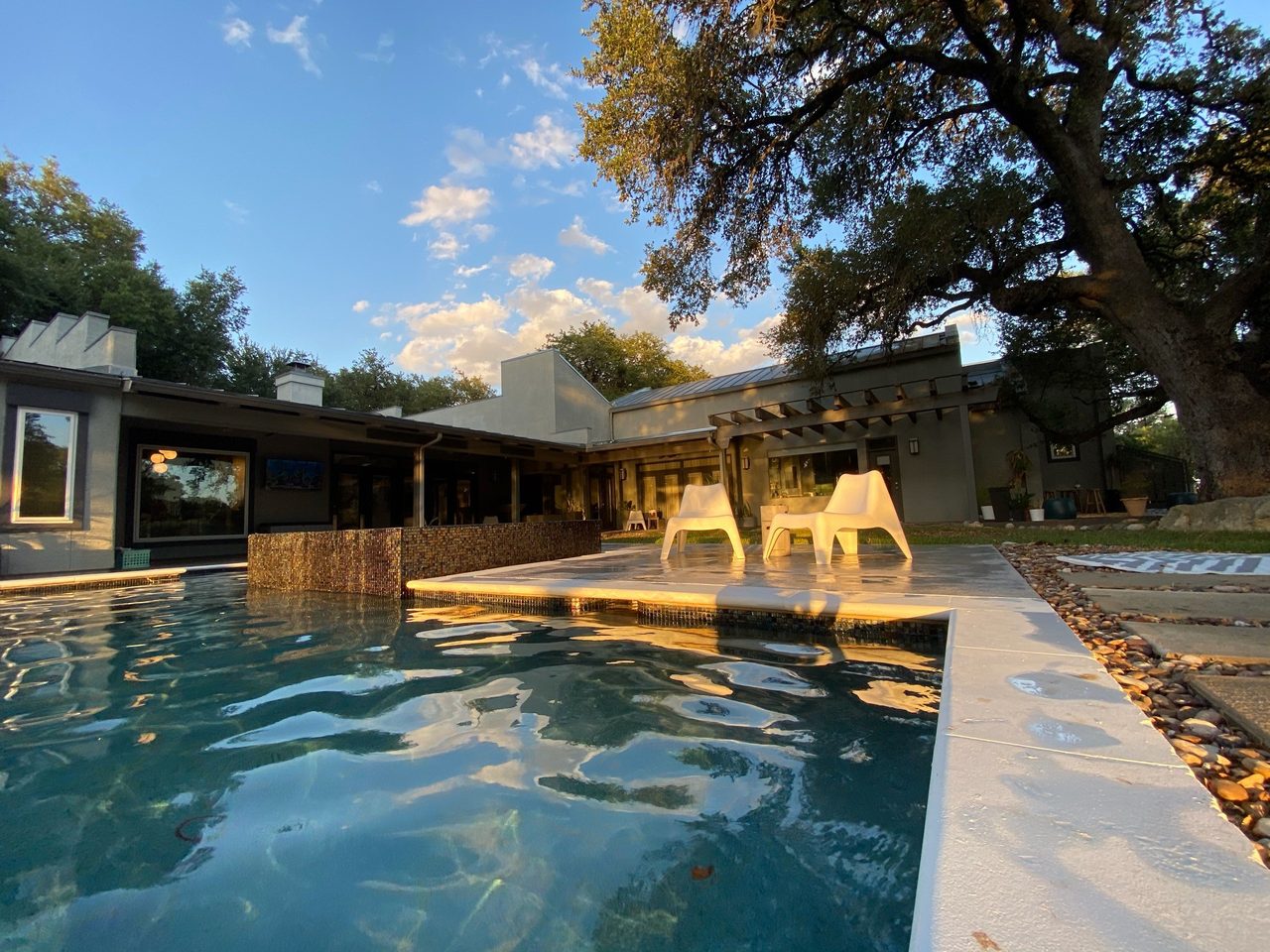 A modern pool with a wide shallow lounging shelf and clear water