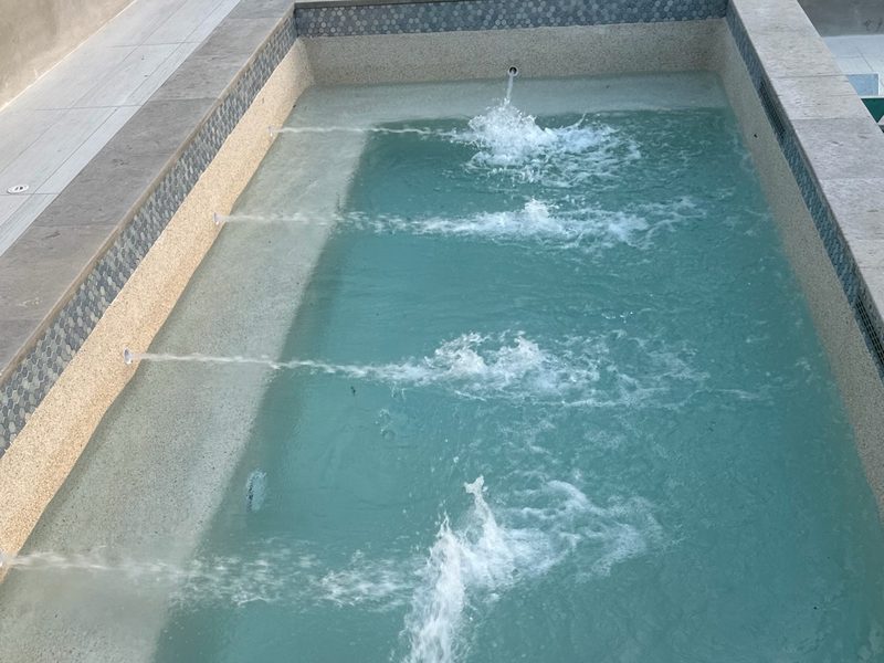 A small stone-edged spa with its jets running